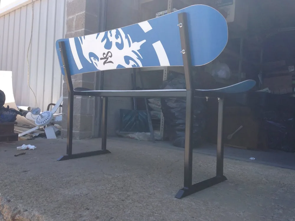 Custom bench fabricated from a snowboard and black steel